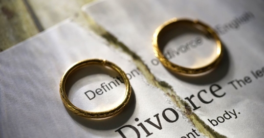 divorce papers and wedding rings