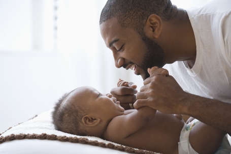 father laughing with baby