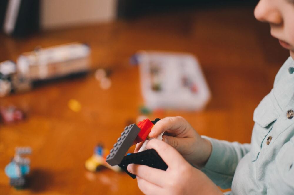 Young boy playing with Legos.